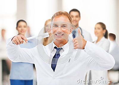 Dentist with toothbrush in hospital Stock Photo