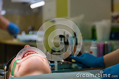 Dentist treat a female patient in dentistry. Treatment concept. Stomatological tool kit. Closeup hightech Dentist equipments Stock Photo