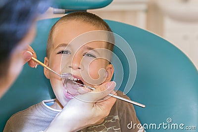 Dentist is treating a boy& x27;s teeth.Children& x27;s dentistry, Pediatric Dentistry. A female stomatologist is treating teeth of Stock Photo