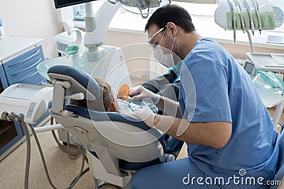 Dentist Treating Child in Modern Clinic Stock Photo