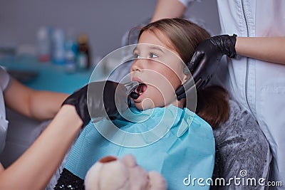 Dentist use anesthetic injection for tooth extraction in child. Stock Photo