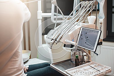 A dentist using his dental equipments on a patient Stock Photo