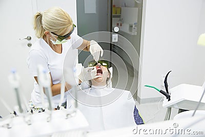 Dentist using a modern diode dental laser Stock Photo