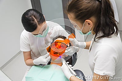 Dentist whiten your teeth his patient Stock Photo