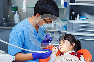 Dentist at work. Doctor and his young patient who is not afraid Stock Photo