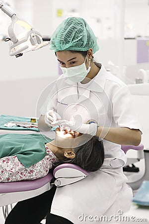 Dentist working on and old patient Editorial Stock Photo