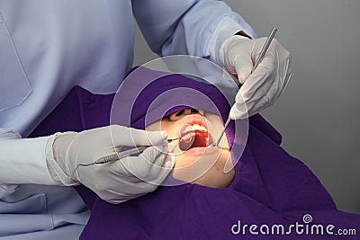 Dentist working on patient Editorial Stock Photo