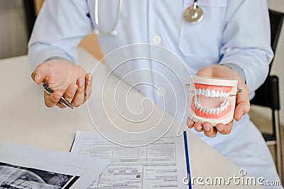 Dentists are discussing dental problems at report x-ray image for patients Stock Photo