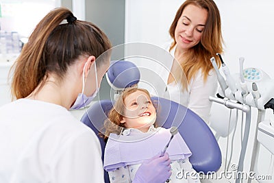 Dentists examining little girl Stock Photo