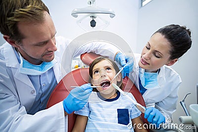Dentists examining young patient in dental clinic Stock Photo