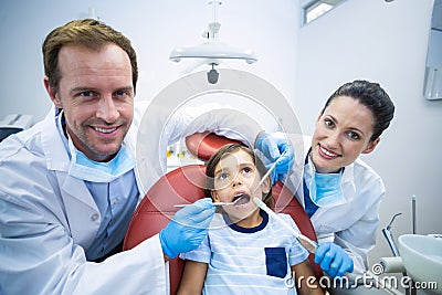 Dentists examining young patient in dental clinic Stock Photo