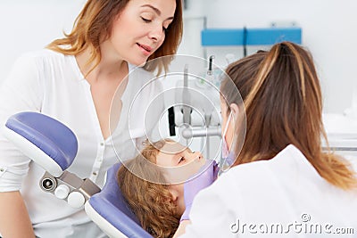 Dentists making treatment for little girl Stock Photo