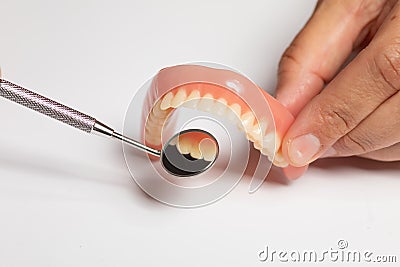 Doctor checking Denture prosthesis, checking with mirror Stock Photo