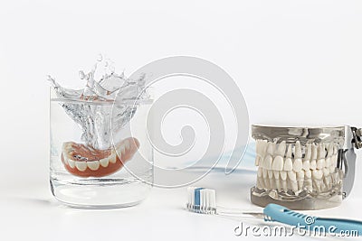 Dentures mold splashing in water Stock Photo