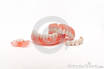 Dentures on a white background. Close-up of dentures. Full removable plastic denture of the jaws. Prosthetic dentistry. Stock Photo