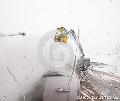 View from passenger window of de-icing of aircraft wing Editorial Stock Photo