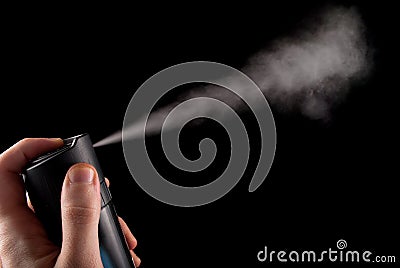 Freshness Unleashed: Deodorant Spray in Hand and Aerosol Can on Black Background Stock Photo