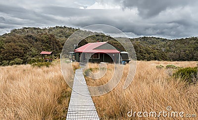 A department of conservation hut perched on the plains in new zealand native bush Stock Photo