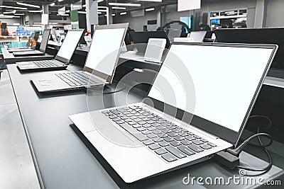 Department of laptops in the electronics store. Table showcase with laptops in the technology store. Choosing and buying a laptop Stock Photo