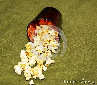 Popcorn in a glass on a green background. Stock Photo