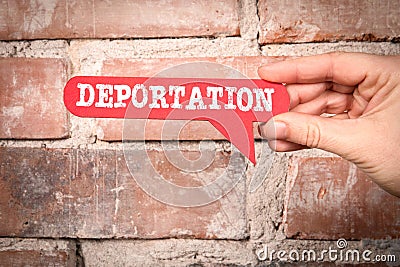 Deportation. Red speech bubble with text on a red brick background Stock Photo