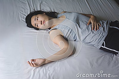 Depress and hopeless woman laying on bed Stock Photo