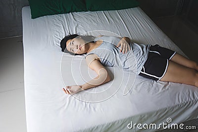 Depress and hopeless woman laying on bed Stock Photo