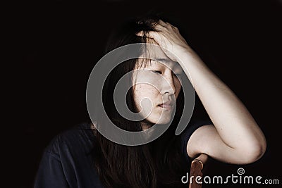 Depress and hopeless woman sitting on chair Stock Photo