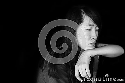 Depress and hopeless woman sitting on chair Stock Photo