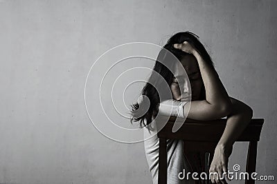 Depress and hopeless woman sitting on chair Stock Photo