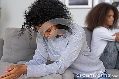 Depressed black mom and daughter avoid talking after fight Stock Photo