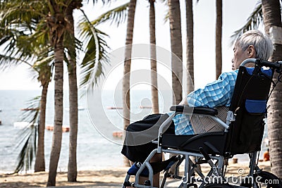 Depressed asian senior grandmother in a wheelchair thinking alone on sea shore sad old elderly patient looking at sea feel Editorial Stock Photo