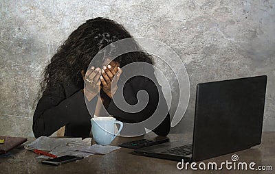 Depressed black African American businesswoman crying sad at office computer desk feeling anxious and overwhelmed surrounded by me Stock Photo