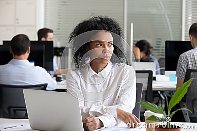 Depressed black woman distracted from work lost in thoughts Stock Photo