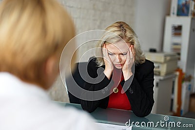 Depressed blonde employee dismissed in office Stock Photo