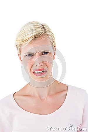 Depressed blonde woman looking at camera Stock Photo