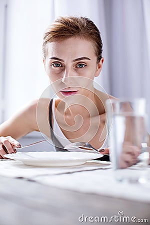 Depressed cheerless woman having breakfast Stock Photo