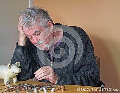 Depressed elderly man counting money. Stock Photo