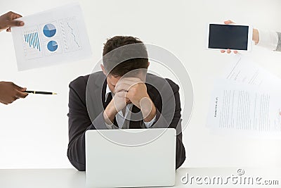 Depressed male employee tired by excessive workload and clients Stock Photo