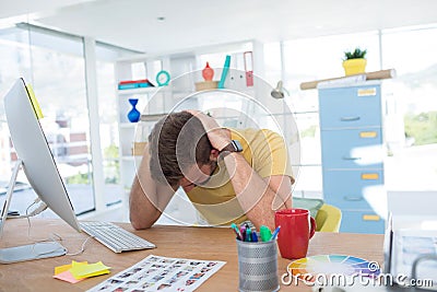 Depressed male executive working on computer Stock Photo