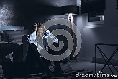 Depressed man alone at home Stock Photo