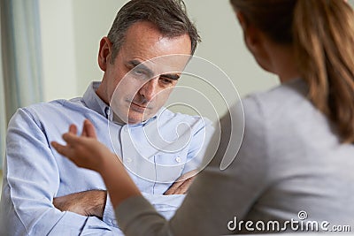 Depressed Mature Man Talking To Counsellor Stock Photo