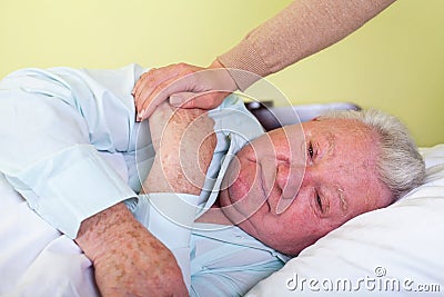 Depressed old man in bed Stock Photo