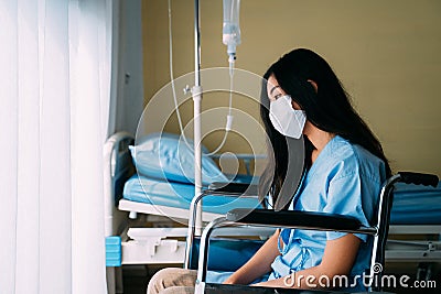 Depressed patient sitting on wheelchair Stock Photo