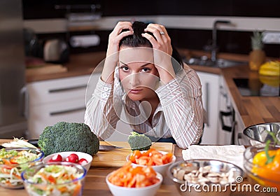 Depressed and sad woman in kitchen Stock Photo