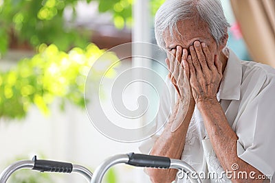 Depressed senior woman covering face with hands,Lonely old people crying alone at home,loneliness,hopelessness,dejection,Sad Stock Photo