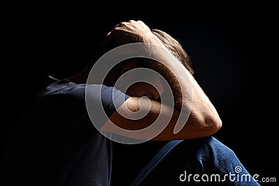 Depressed teenager man in black Stock Photo