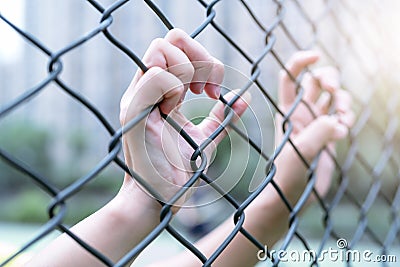 Depressed, trouble and solution. Women hand on chain-link fence. Stock Photo