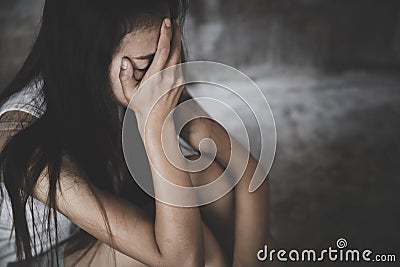 Depressed woman sitting on ground, Fear, loneliness, depression, abuse, female in depression sadness in dark tone Stock Photo