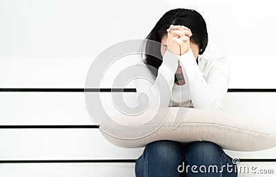 Depressed women sitting and pray in the room, alone, sadness, emotional concept Stock Photo